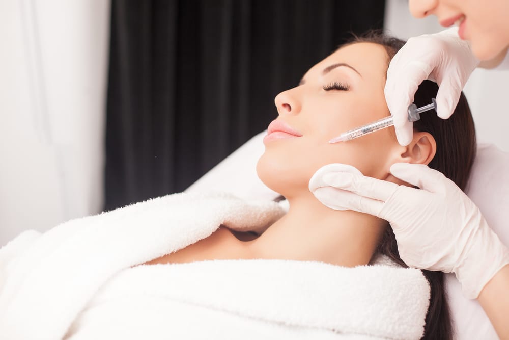Facial Injectable Treatment Enhancing Jawline and Cheek Contours – Dermal Fillers Patient Receiving Precision Facial Injection for Volume Restoration and Contouring – Dermal Fillers