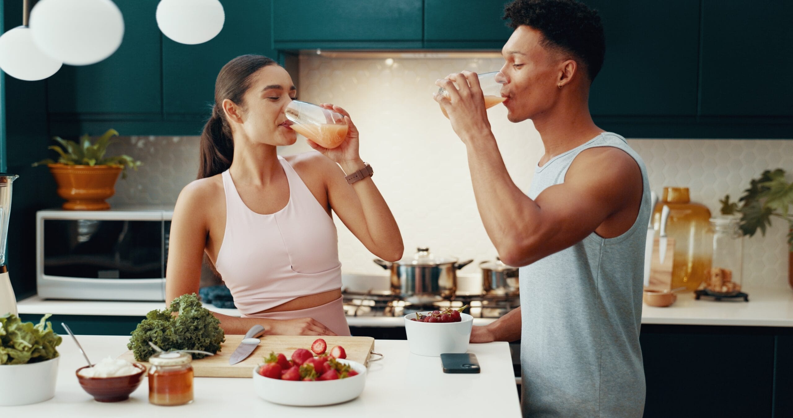 Couple enjoying a nutritious drink together in a modern kitchen while supporting healthy habits as part of a weight loss management journey – Weight Loss Management